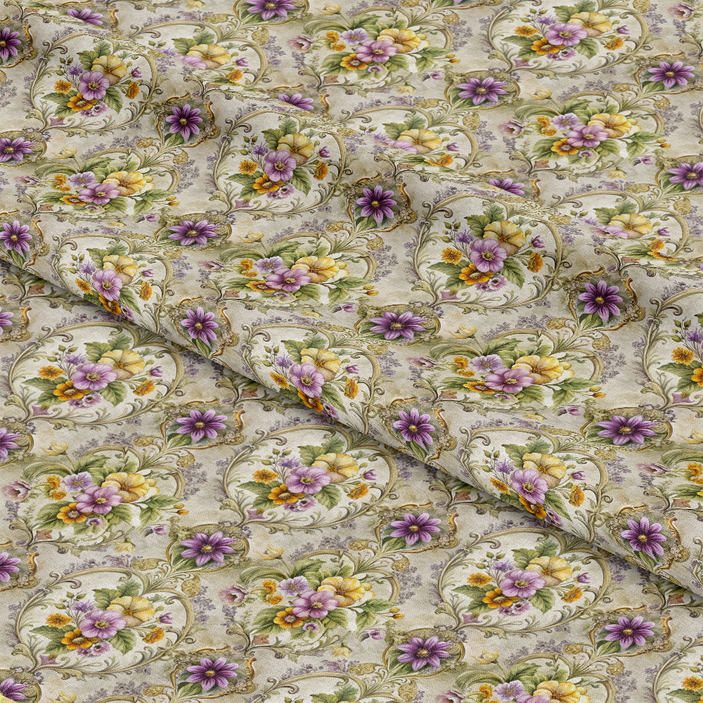 A close-up of fabric featuring a repeating floral pattern with purple, yellow, and orange flowers inside ornate oval frames on a light, textured background. The fabric is gently folded, creating visible creases.