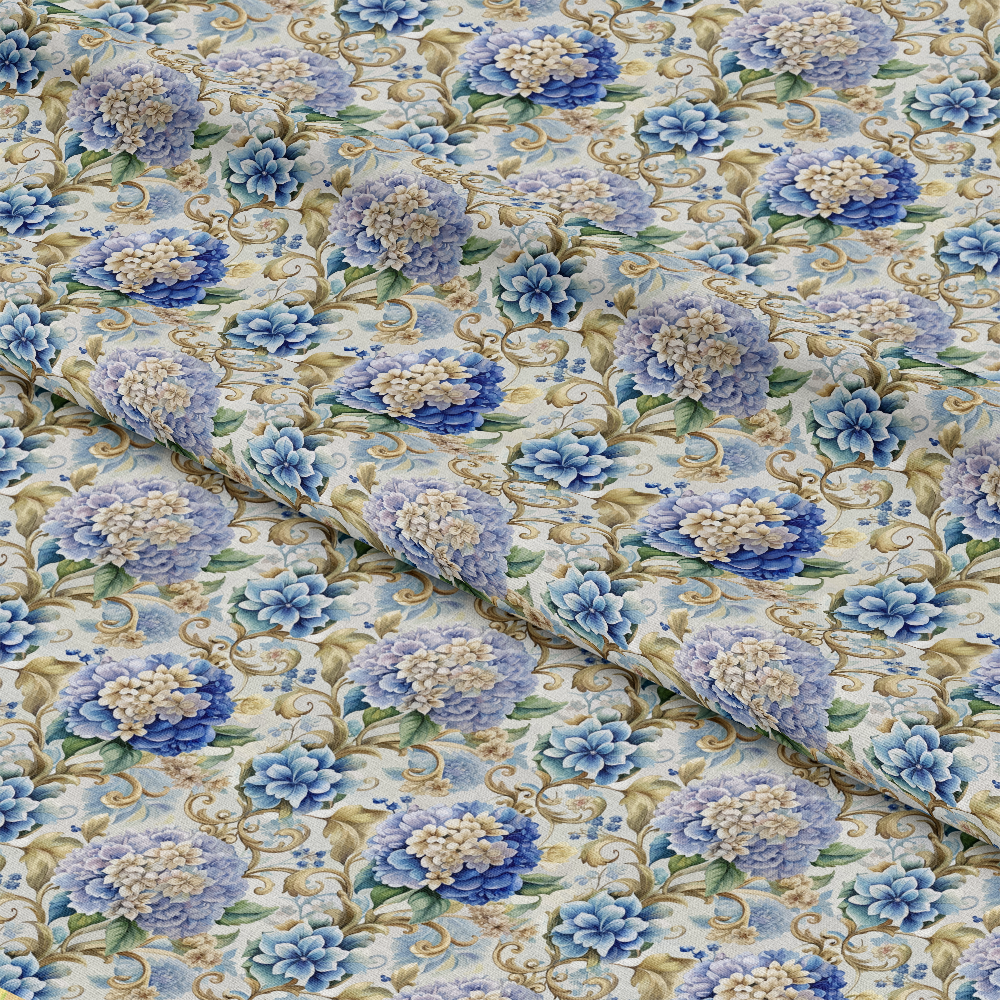 A close-up of fabric with a repeating floral pattern featuring blue and cream flowers, green leaves, and gold scroll designs. The fabric is gently folded, creating visible creases and texture.