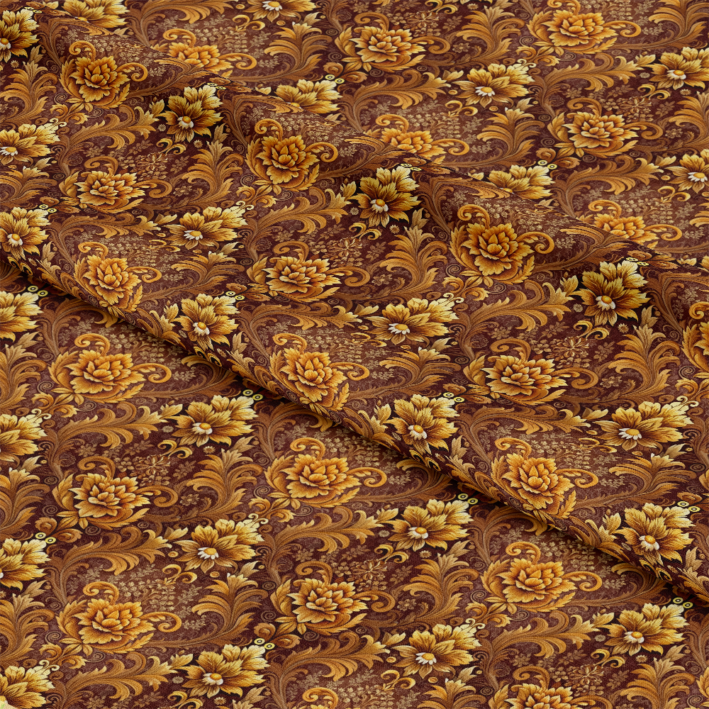 A piece of fabric with an ornate floral pattern in shades of gold and yellow on a brown background, featuring large flowers, leaves, and swirling vines. The fabric is slightly folded in the middle.