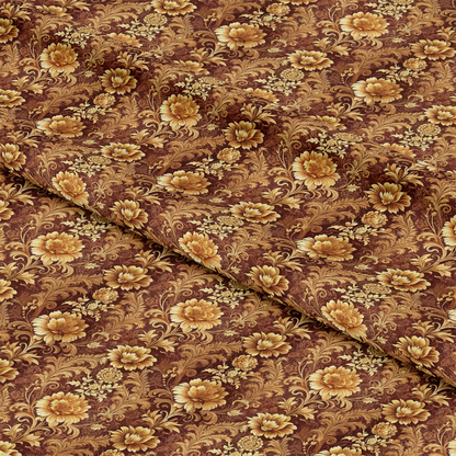 A close-up of fabric with a detailed floral pattern in shades of brown and gold. The fabric is slightly folded, showing intricate flowers and leaves on the surface.