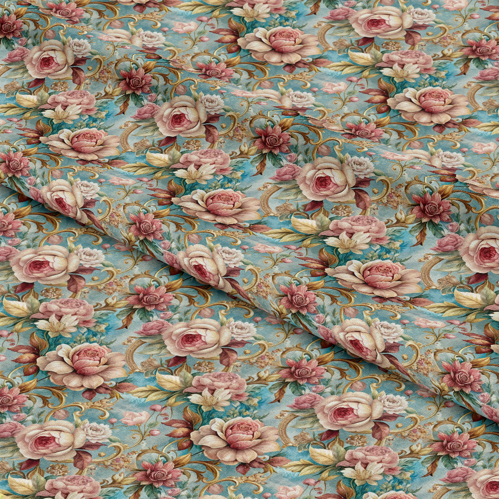 A close-up of folded fabric featuring a floral pattern with pink and white roses, green leaves, and gold vines on a light blue background.