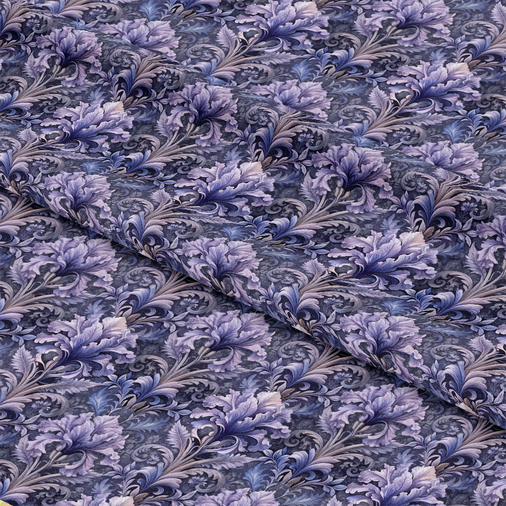 A close-up of fabric with a detailed floral pattern in shades of purple and grey, featuring overlapping leaves and flowers. The fabric is slightly folded, creating gentle diagonal creases.