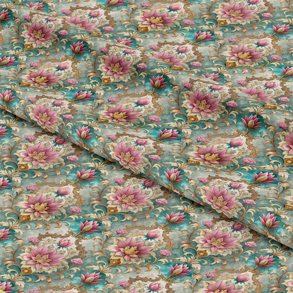 A close-up of fabric with a teal background featuring an intricate floral pattern of pink and yellow lotus flowers, green leaves, and gold ornamental accents. The fabric is slightly folded and textured.
