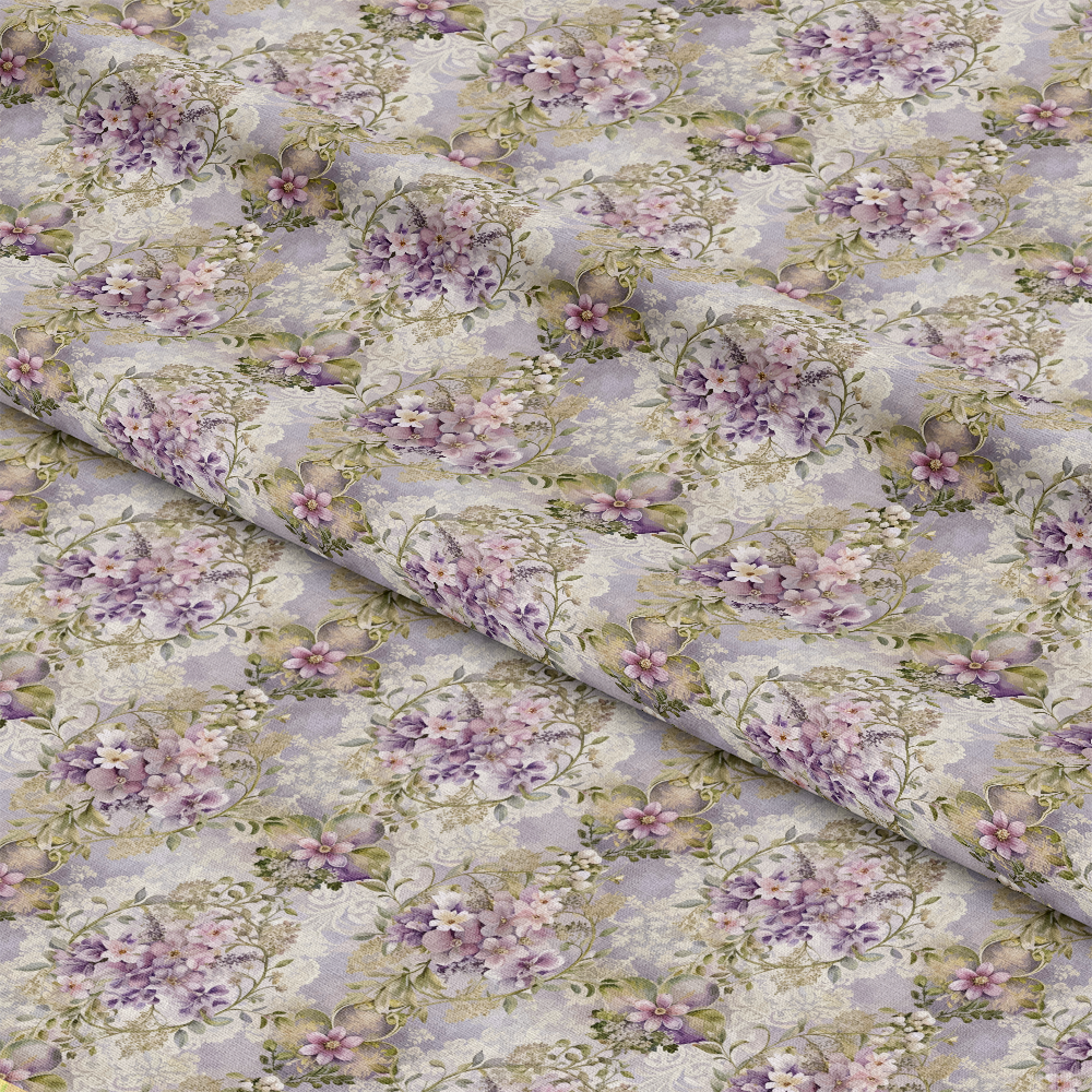 A close-up view of fabric with a repeating floral pattern featuring purple, pink, and white flowers with green leaves on a light background, displayed with gentle folds across the surface.