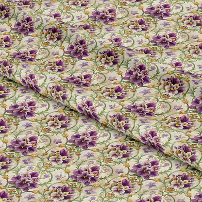 A close-up view of a fabric with a detailed floral pattern featuring purple and yellow flowers, green leaves, and vines on a beige background. The fabric is shown with gentle folds.