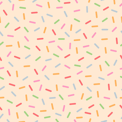 rainbow sprinkles, colorful sprinkles, pink background, peach background, multicolored, candy sprinkles, dessert pattern, fun pattern, whimsical design, bright colors, quilting cotton, fabric panel, cheerful mood, bakery theme, sweet treats, scattered pattern, playful design, orange sprinkles, blue sprinkles, green sprinkles