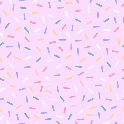 rainbow sprinkles, multicolored confetti, pink background, pastel colors, yellow sprinkles, blue sprinkles, green sprinkles, coral sprinkles, white sprinkles, scattered pattern, random placement, quilting cotton, fabric panel, sweet treats, bakery theme, celebration design, cheerful mood, playful pattern, dessert inspired, candy colors