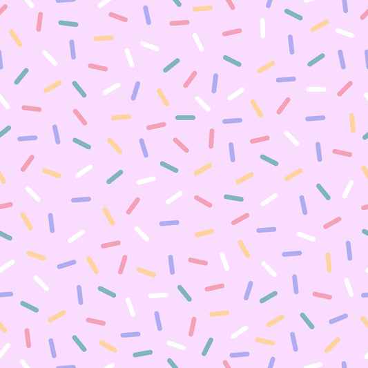 rainbow sprinkles, multicolored confetti, pink background, pastel colors, yellow sprinkles, blue sprinkles, green sprinkles, coral sprinkles, white sprinkles, scattered pattern, random placement, quilting cotton, fabric panel, sweet treats, bakery theme, celebration design, cheerful mood, playful pattern, dessert inspired, candy colors